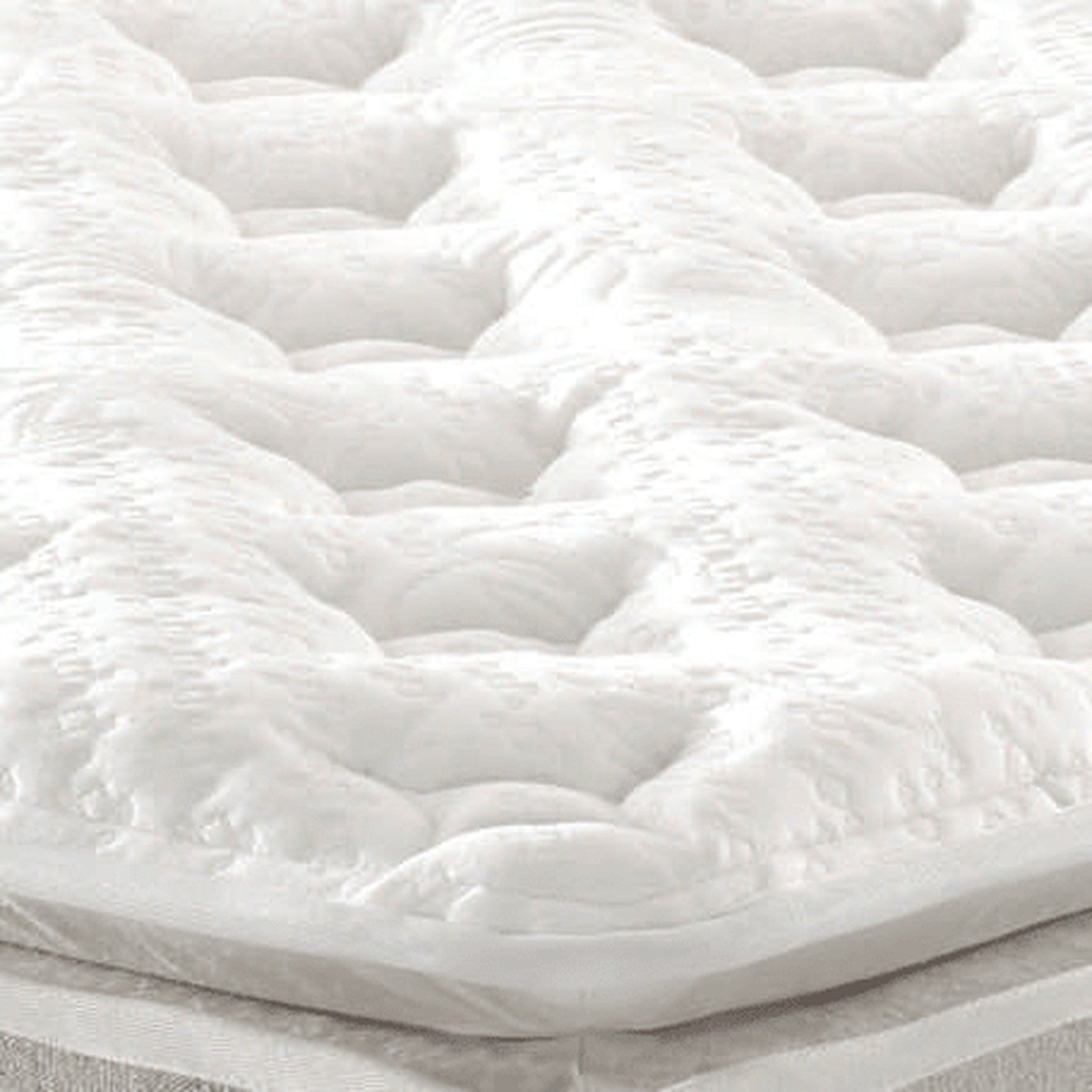 Colchão Amalfi com detalhe do acolchoado branco em alto-relevo.