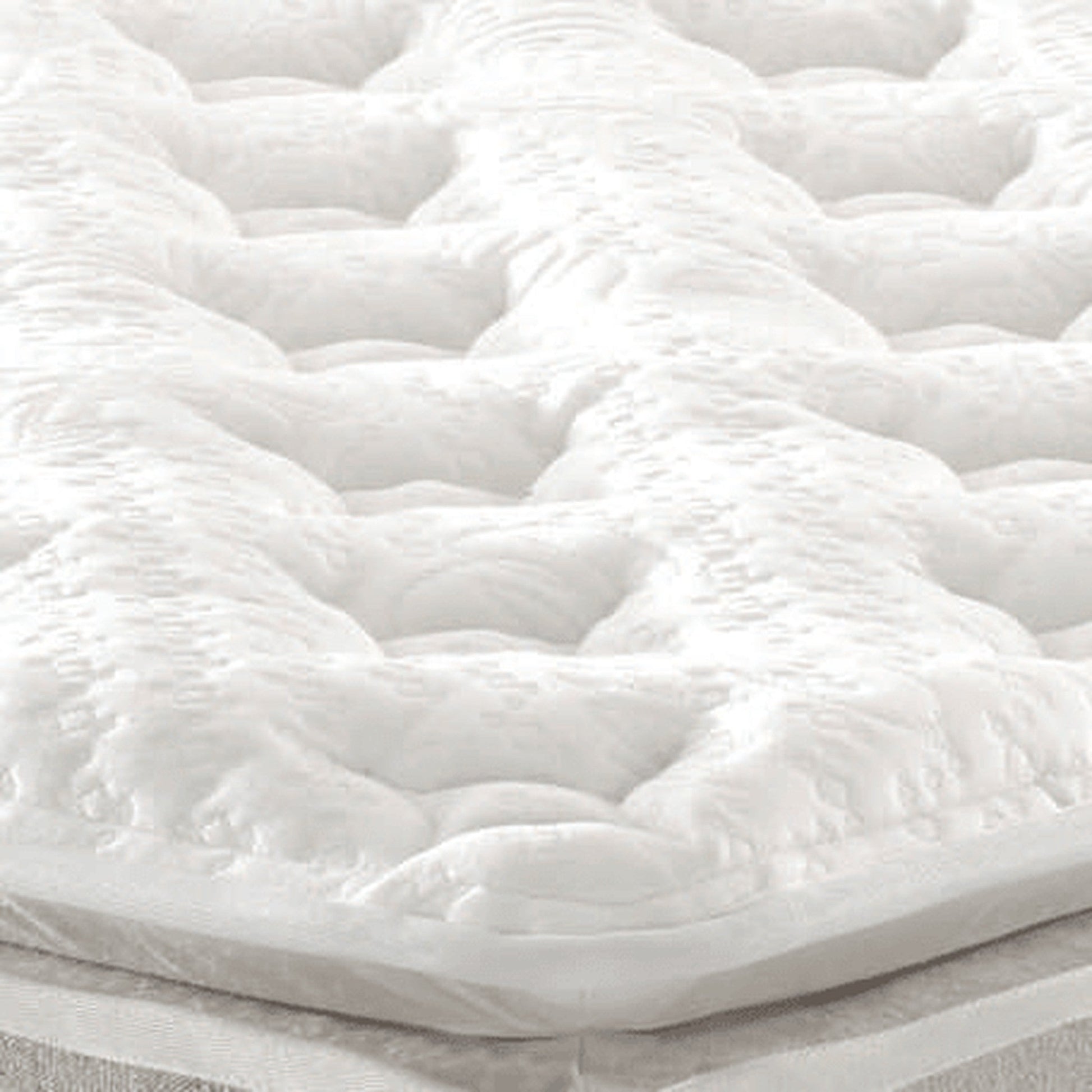 Colchão Amalfi com detalhe do acolchoado branco em alto-relevo.