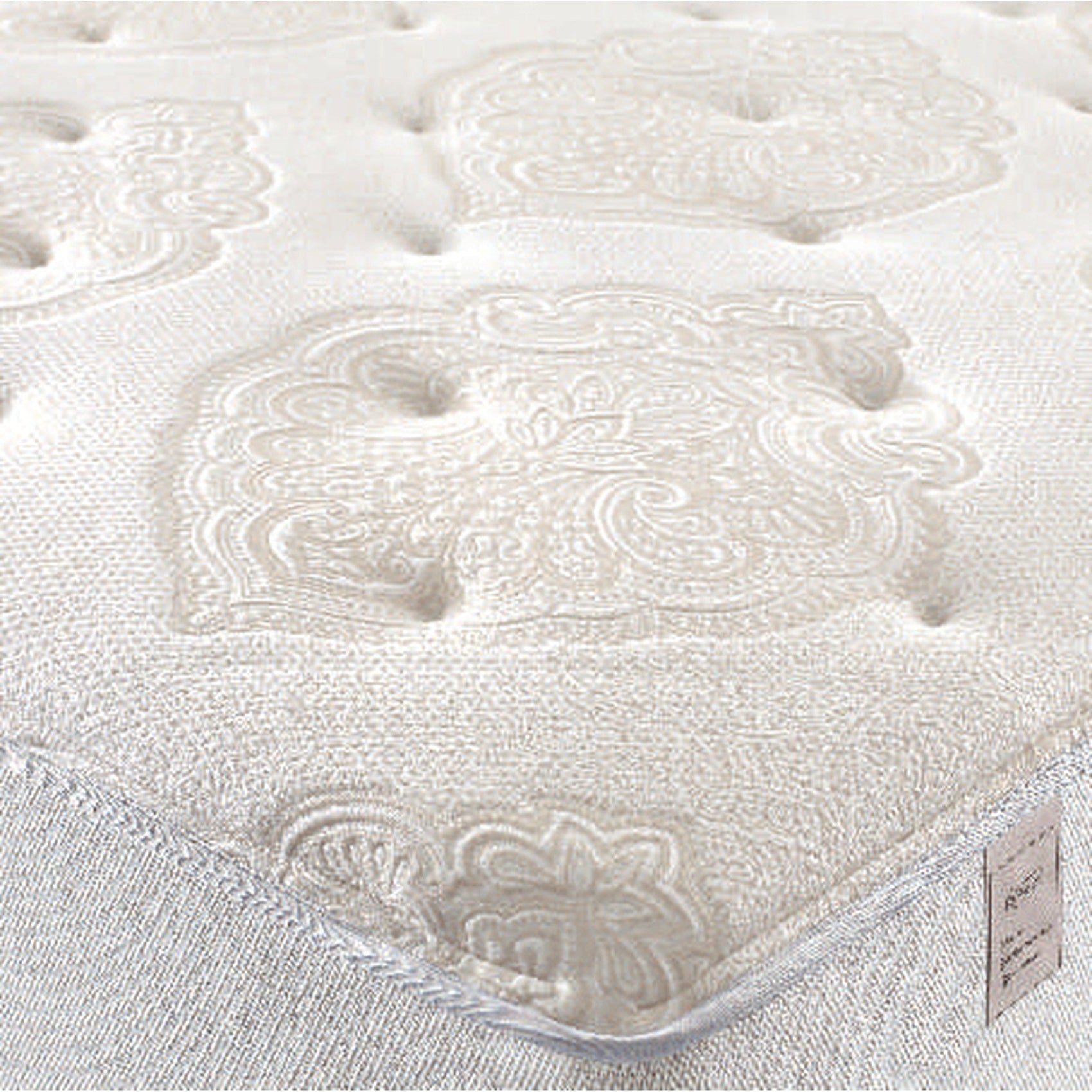 Colchão com tecido branco texturizado e desenhos em relevo na superfície