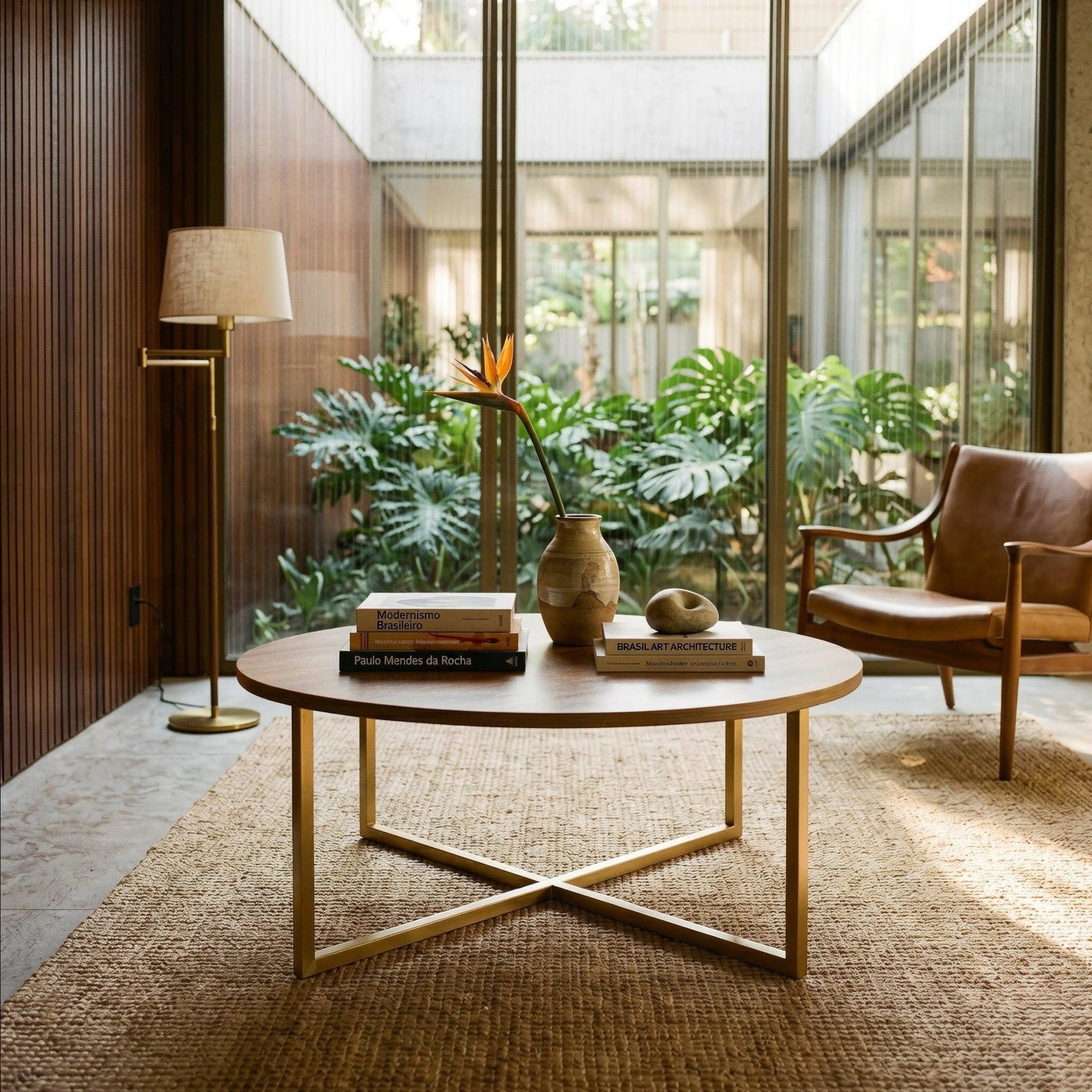 Horizon Interiores Zari round coffee table with light wood top and gold metal base. Modern design for living room.