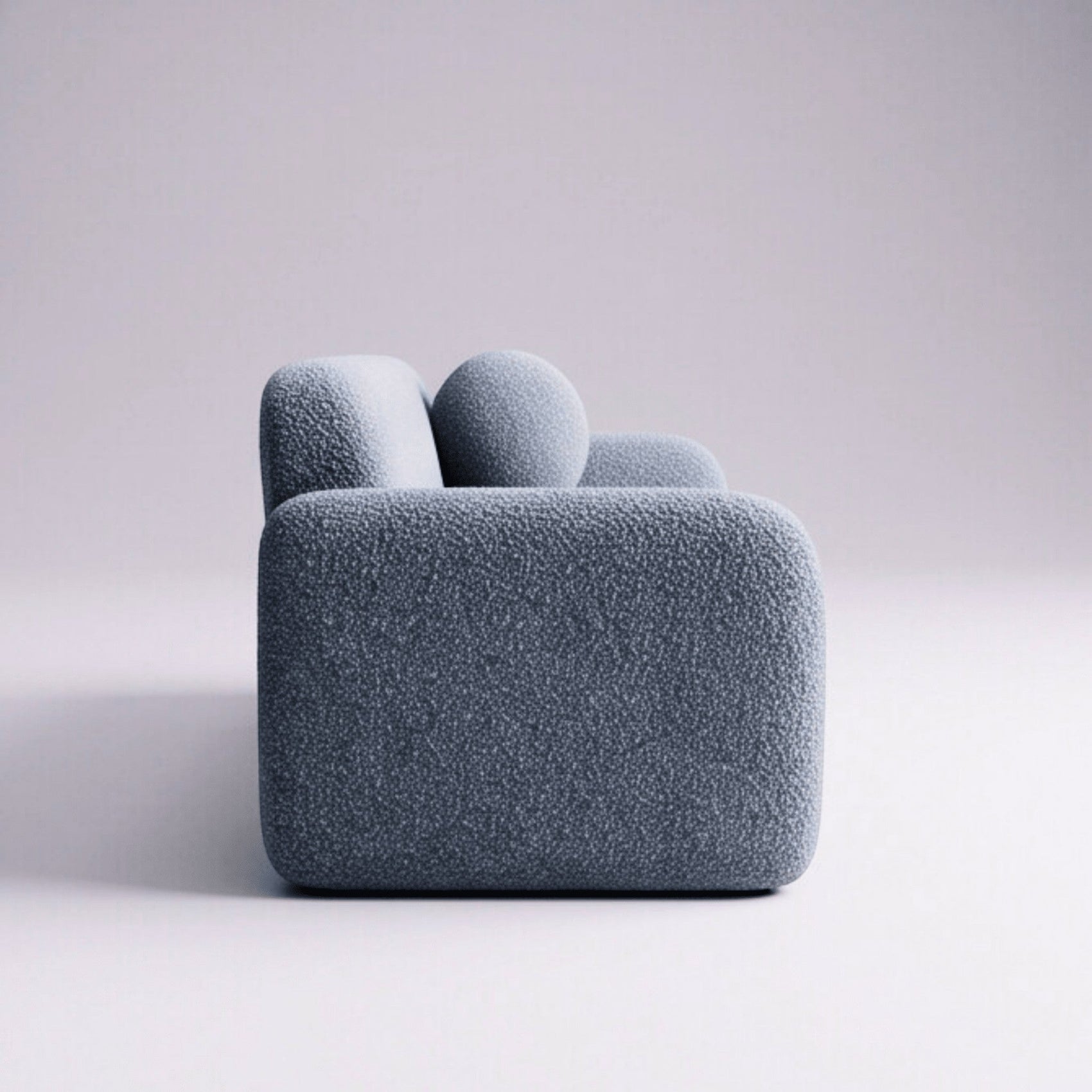 Sofá-cama estofado azul escuro com encosto alto e almofadas redondas